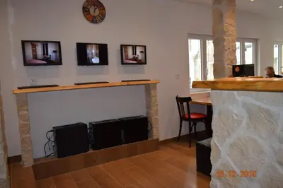a living room with a fireplace with a clock on the wall at Hôtel Lyonnais in Nice