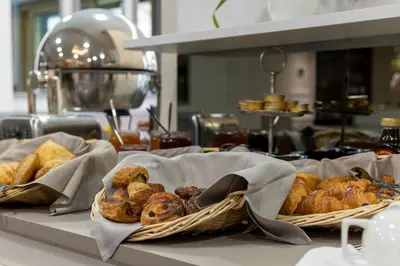 a basket of bread and pastries on a counter at Hôtel Petit Palais in Nice