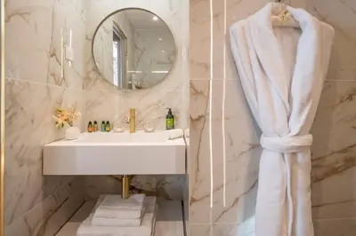 a bathroom with a sink and a mirror at Hôtel Petit Palais in Nice