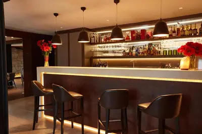 a bar with black stools in a restaurant at Hôtel Eze Hermitage in Èze