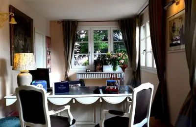 a room with a desk with chairs and a window at Hôtel Eze Hermitage in Èze