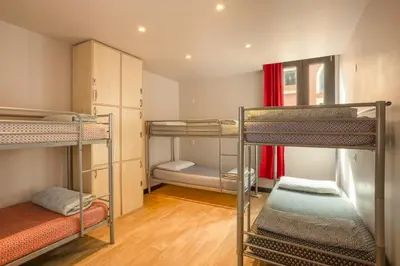a room with three bunk beds in it at Villa Saint Exupery Beach Hostel in Nice