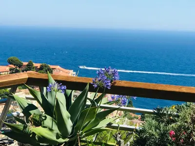 a table and chairs on a deck with a view of the ocean at COSTA PLANA COLLECTION - Cap d'Ail - Monaco in Cap d'Ail