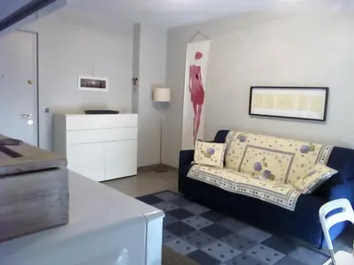 a living room with a couch and a table at Appartement Cattleya - rue halevy in Nice