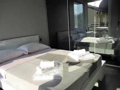 two beds in a room with a mirror at Appartement Cattleya - rue halevy in Nice