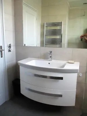 a bathroom with a white sink and a mirror at Appartement Cattleya - rue halevy in Nice