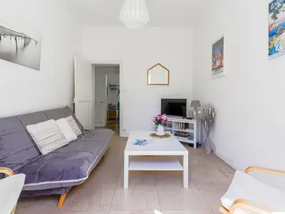 a living room with a couch and a table at Apartment Hérold-1 by Interhome in Nice