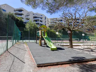 a playground with a slide in a park at Studio Ciel de Fabron by Interhome in Nice