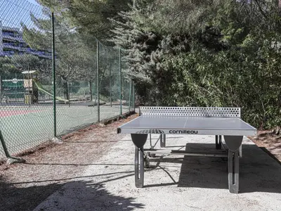 a ping pong table in front of a tennis court at Studio Ciel de Fabron by Interhome in Nice