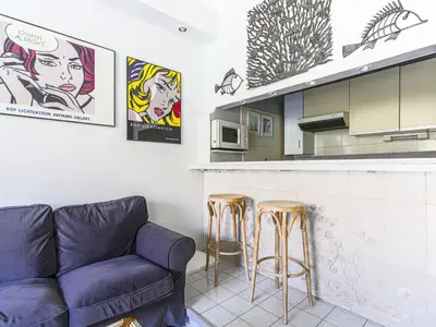a living room with a couch and two bar stools at Apartment Le Concordia by Interhome in Nice