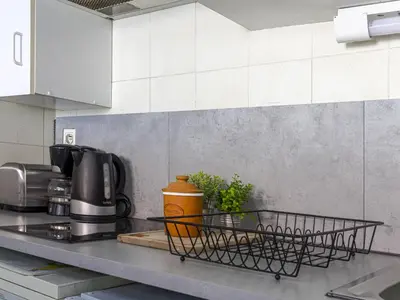 a kitchen counter with a dish drying rack on it at Apartment Le Concordia by Interhome in Nice