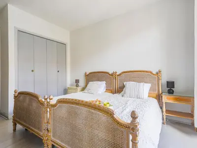 a bedroom with a large wicker bed and a dresser at Apartment Le Concordia by Interhome in Nice