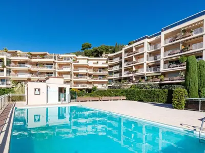 a swimming pool in front of a large apartment building at Apartment Les Balcons d'Eze-1 by Interhome in Èze