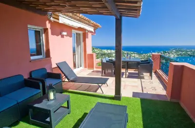 a patio with chairs and a table on a balcony at Le Rooftop 180 in Villefranche-sur-Mer