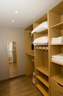 a closet with wooden shelves and a hallway at Le Rooftop 180 in Villefranche-sur-Mer