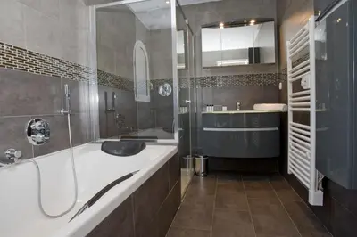 a bathroom with a tub and a sink and a shower at Le Rooftop 180 in Villefranche-sur-Mer