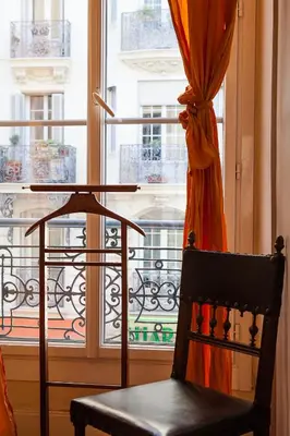 a chair sitting in front of a window at Nice Riviera Sweet Home Chambres d'hotes in Nice