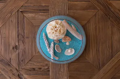 a blue plate with food on a wooden table at Le Corot in Beaulieu-sur-Mer