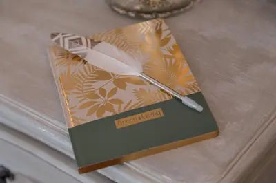a book with a clock on top of a table at Le Corot in Beaulieu-sur-Mer