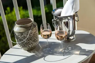 a table with two glasses of wine and a pitcher at Le Corot in Beaulieu-sur-Mer