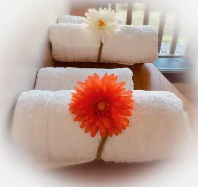 four towels with a flower on top of them at La Coulina in Nice