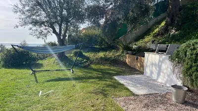a hammock in the grass in a yard at La Coulina in Nice