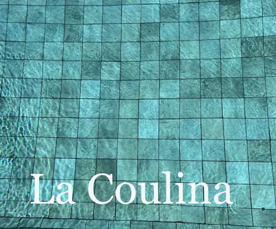 a sign that says la coluna on a tile floor at La Coulina in Nice