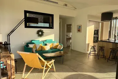 a living room with a green couch and chairs at La Coulina in Nice