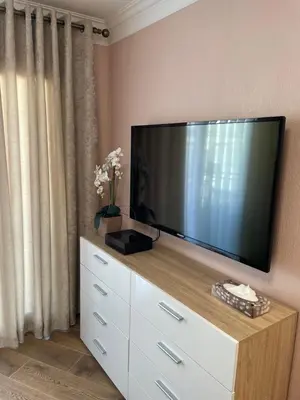 a flat screen tv sitting on top of a dresser at Studio With Swimming Pool 80 meters near the beach in Nice