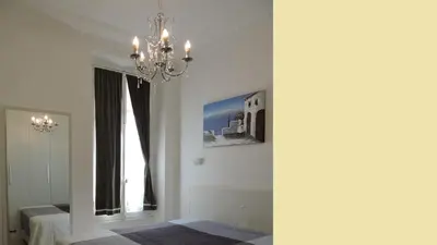 a chandelier hanging in a room with a window at NICE FRANCE Apartment 2 rooms max 4 persons in Nice