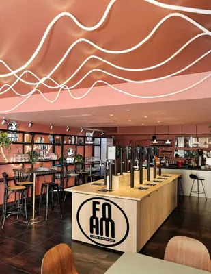 a restaurant with a bar with a curved ceiling at Hotel du Pin Nice Port in Nice