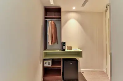 a walk in closet with a green counter and a shelf at Hotel du Pin Nice Port in Nice
