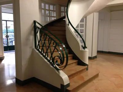 a spiral staircase in a house with wooden floors at Centre, deux pièces, calme, terrasse plein sud in Nice