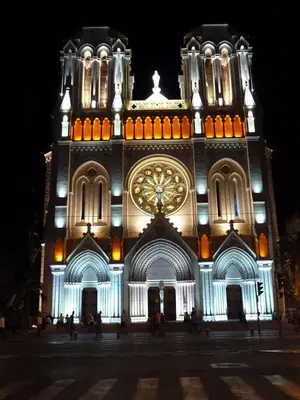 a large building with a clock tower at night at Centre, deux pièces, calme, terrasse plein sud in Nice