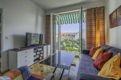 a living room with a couch and a tv at Centre, deux pièces, calme, terrasse plein sud in Nice