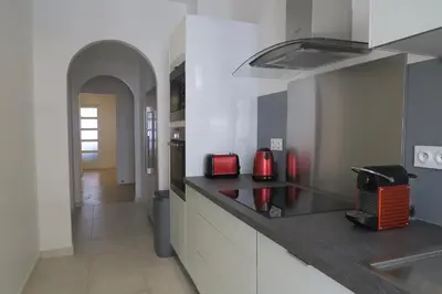 a kitchen with a counter top with red appliances at Carré d’Or Appt 4 Pièces moderne et spacieux in Nice