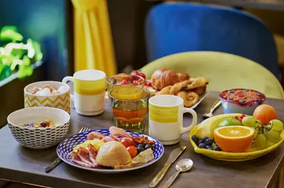 a table topped with plates of breakfast foods and drinks at Hotel Nap By HappyCulture in Nice