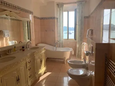 a bathroom with two sinks and a tub and a toilet at Seagulls in Villefranche-sur-Mer