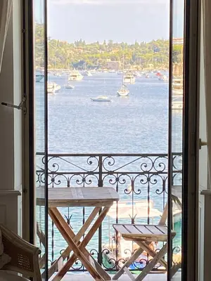 a small bedroom with a bed in a room at Seagulls in Villefranche-sur-Mer