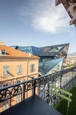 a balcony with a view of the louvre at Homelivia Av Jean Médecin in Nice