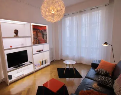 a living room with a couch and a tv at Le Maréchal in Nice