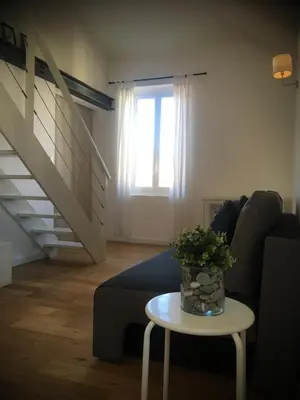 a white staircase with glass shelves in a living room at Charme Méditerranéen Votre pied à terre au Cœur du Port de Nice in Nice