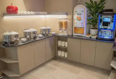 a kitchen with a counter with a drink machine at Hotel Lou Castelet in Carros