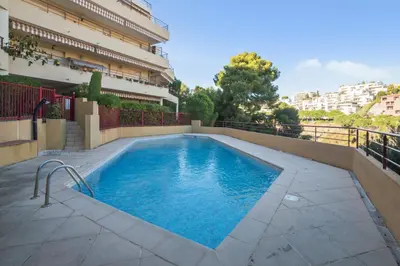 a swimming pool in front of a building at Appartement Lanterne Welkeys in Nice