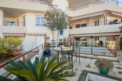 an apartment building with a balcony and a patio at Appartement Lanterne Welkeys in Nice