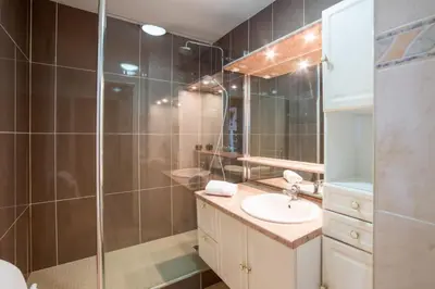 a bathroom with a sink and a shower at Appartement Lanterne Welkeys in Nice