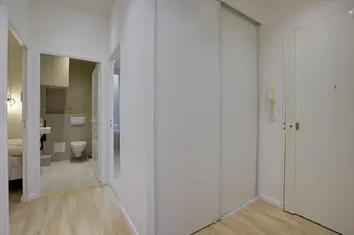 a bathroom with white walls and a toilet in a room at Maison Bianchi - Raspail in Nice