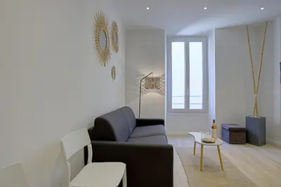 a living room with a couch and a table at Maison Bianchi - Raspail in Nice