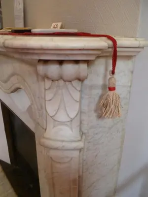 a white vase with a broom on top of it at Hotel Victor Hugo Nice in Nice