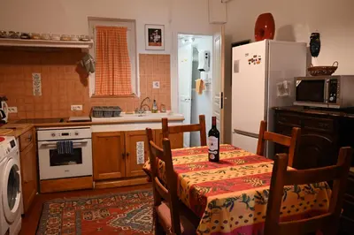 a kitchen with a table and a white refrigerator at Family Apartment 2BR Old Town near Beach AC in Nice